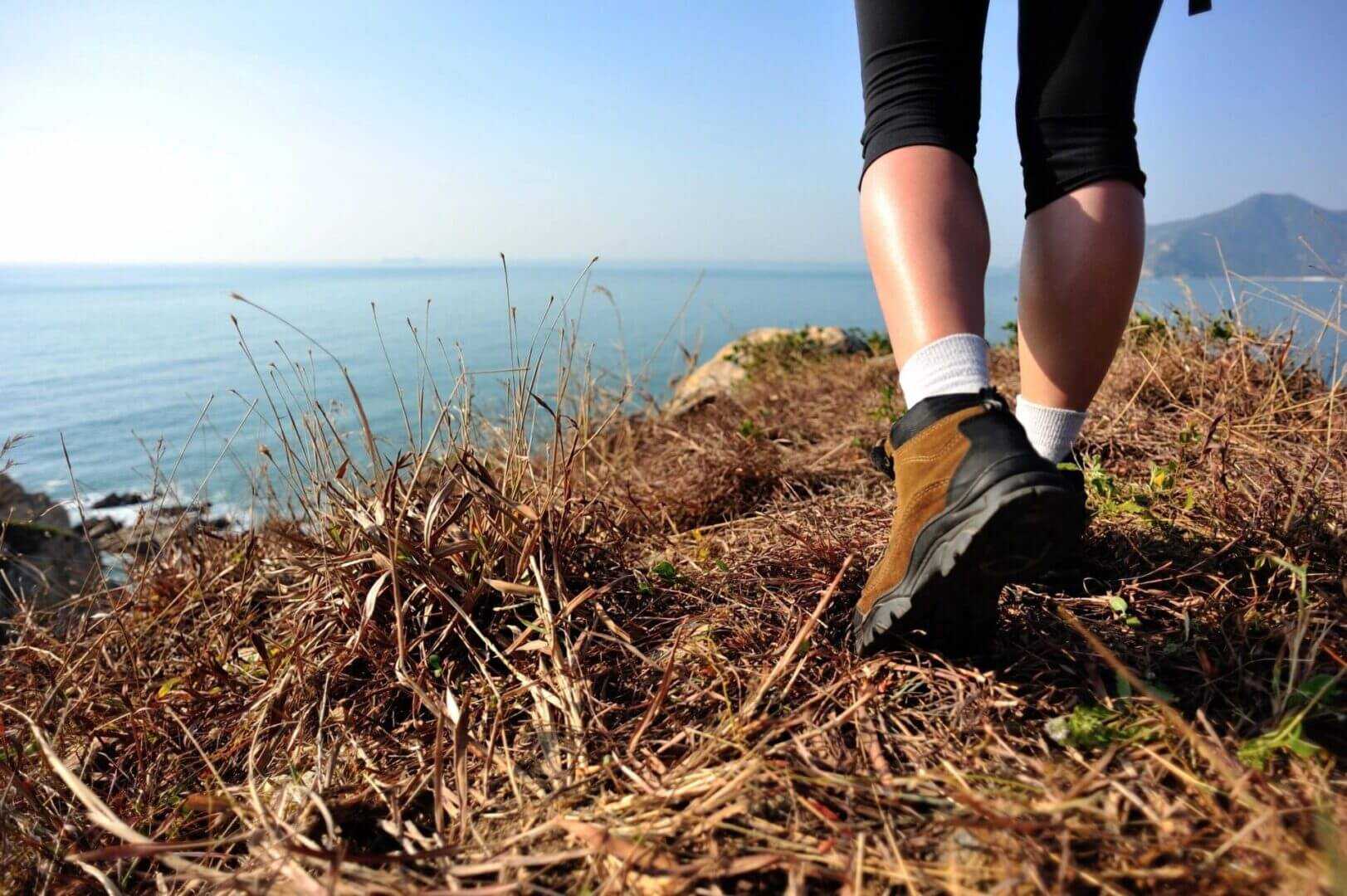 Hiking along a coastal cliff edge.